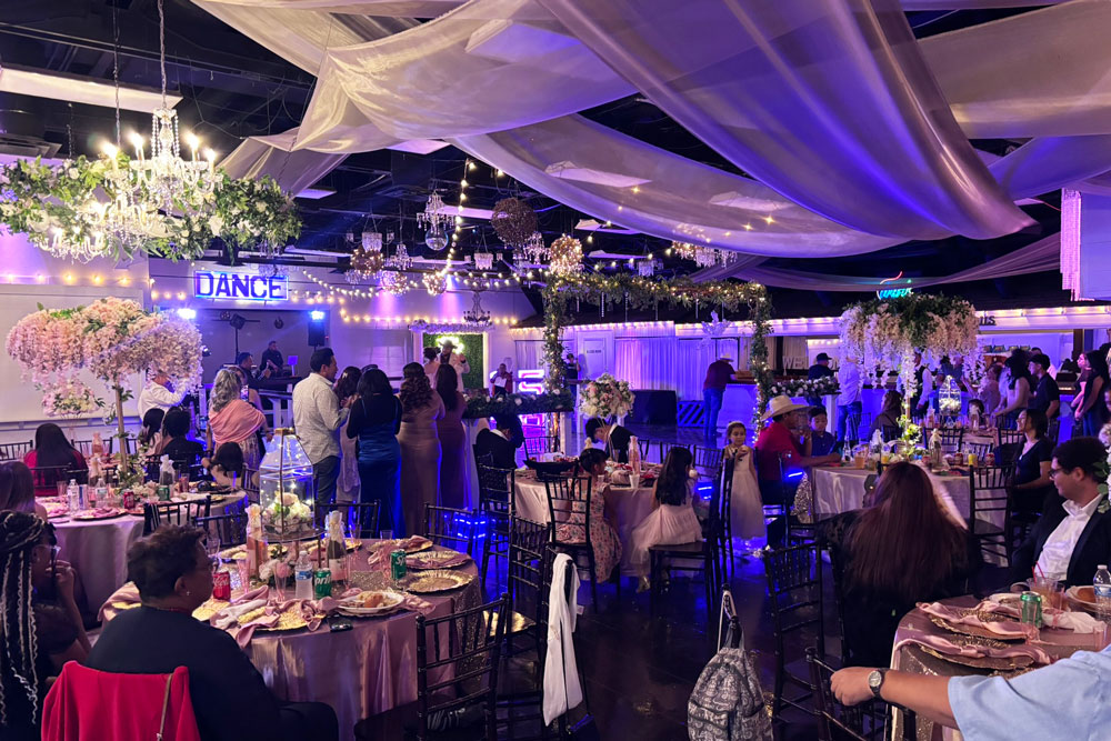 Guests celebrating inside a decorated ballroom at The Chateau at Forest Park